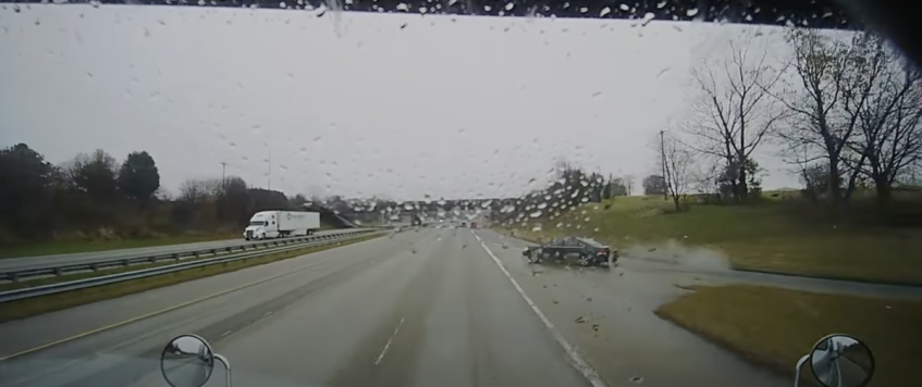 VIDEO: Guardrail saves the day after car crash causes trucker to lose control